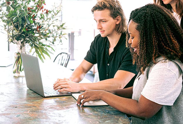 Rijksmedewerkers aan tafel met een laptop